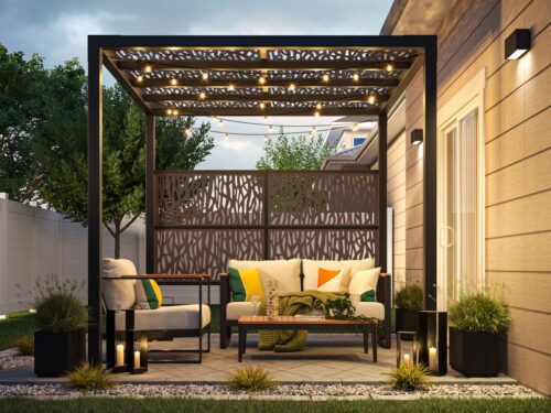 MoistureShield composite decking in a Nashville backyard with a matte-black pergola, decorative screen panel, outdoor seating, and warm evening lighting.