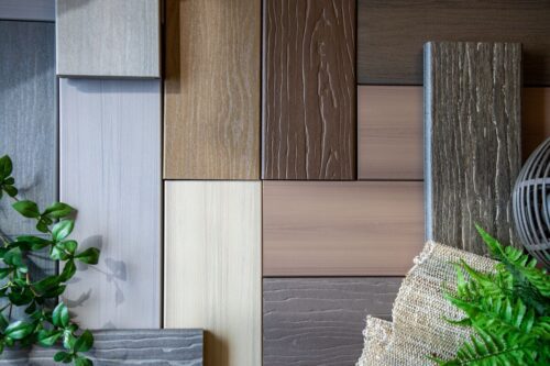 Assorted MoistureShield composite decking samples arranged in a flat lay, showing multiple colors, grains, and textures for outdoor projects.