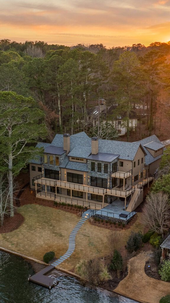 lake-windward-timbertech-deck-trespa-siding- Modern lakefront deck with TimberTech composite decking and Trespa siding.