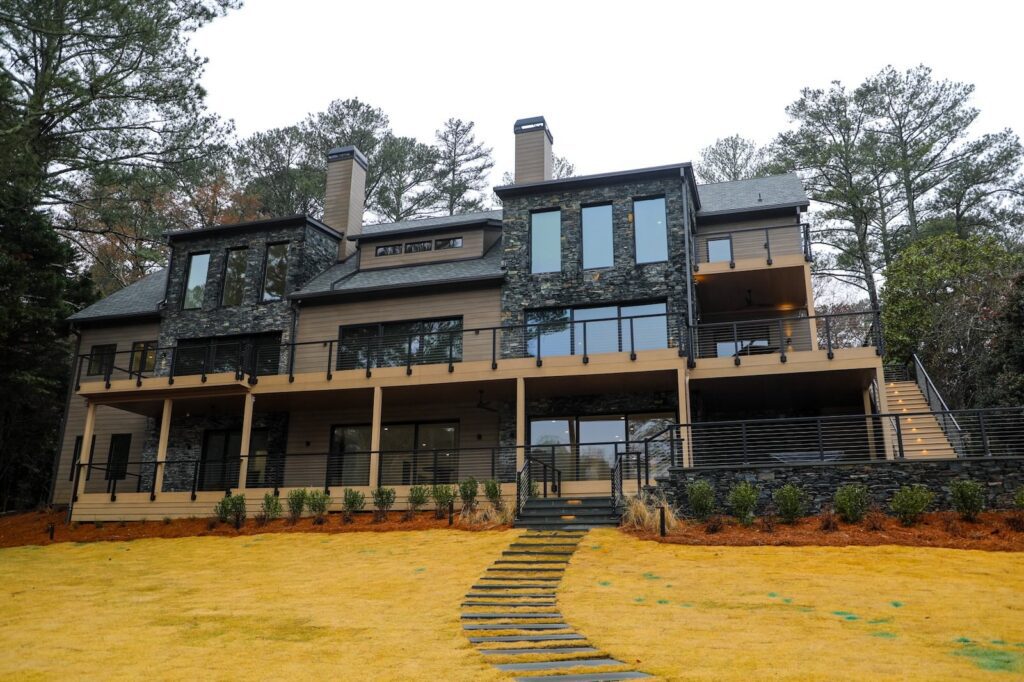 lake-windward-timbertech-deck-trespa-siding- TimberTech decking with custom metal railing installation by Boyce Design + Build.