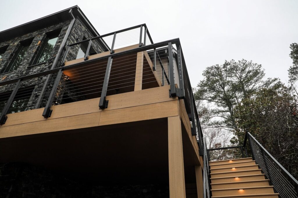 lake-windward-timbertech-deck-trespa-siding- TimberTech deck corner with custom metal railing detail.