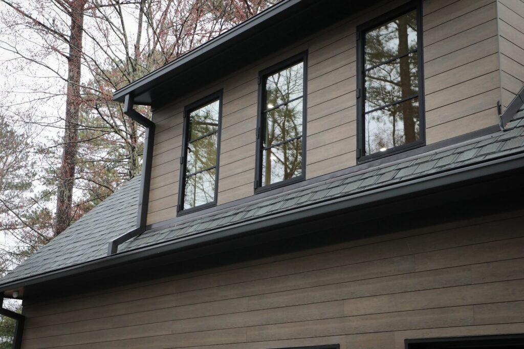 lake-windward-timbertech-deck-trespa-siding- Upper-level TimberTech deck with lake view by Boyce Design + Build.