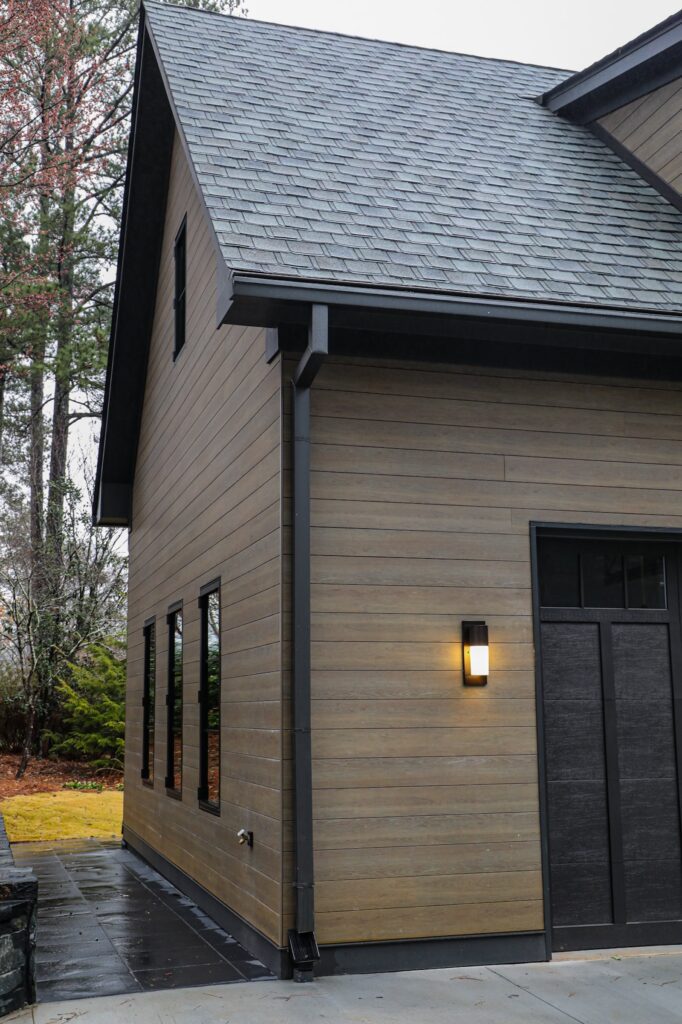 lake-windward-timbertech-deck-trespa-siding- TimberTech composite decking with natural wood grain texture and clean lines.