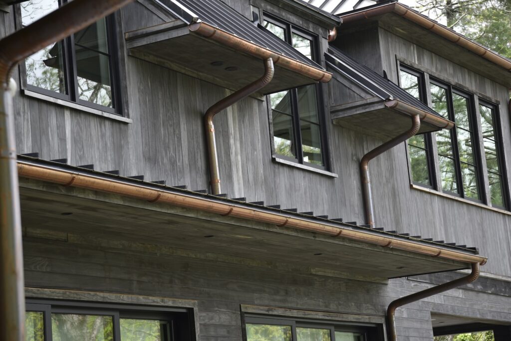 Accoya Grey cladding with refined architectural transitions at the outdoor kitchen area.