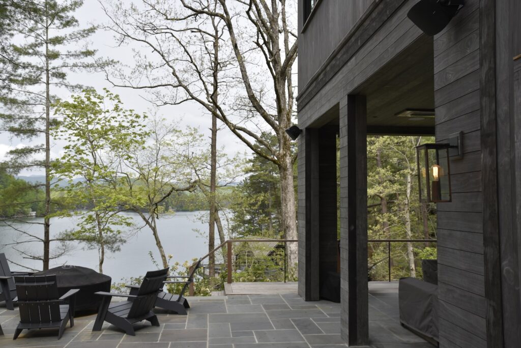 Ipe dock surface surrounded by lake and tree reflections overlooking the shoreline.