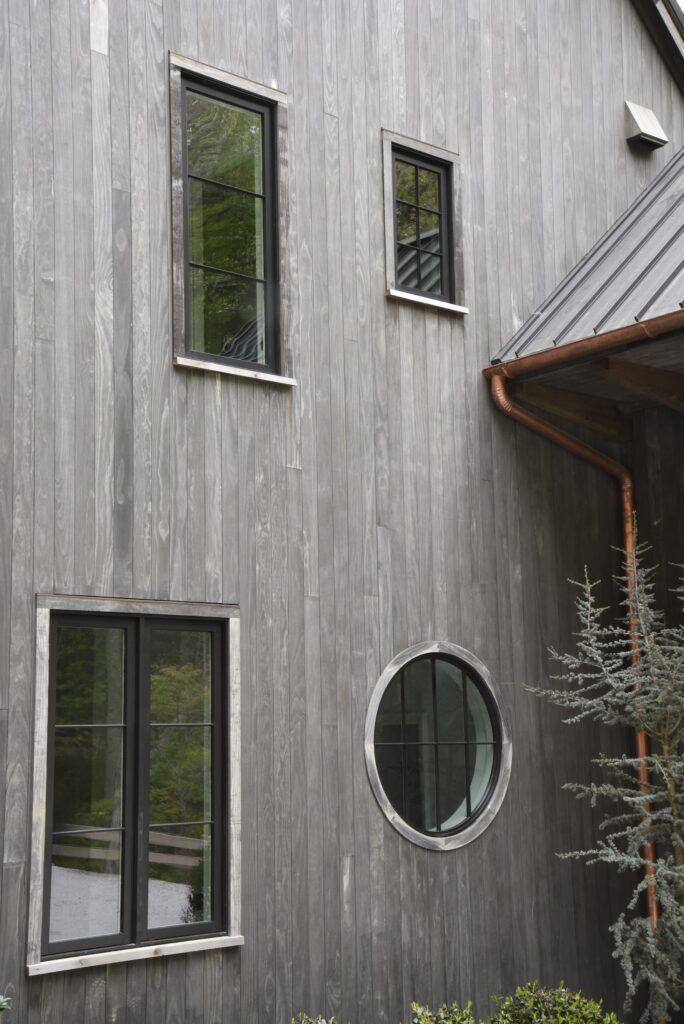 Accoya Grey soffits with clean vertical grain lines at the outdoor kitchen area.