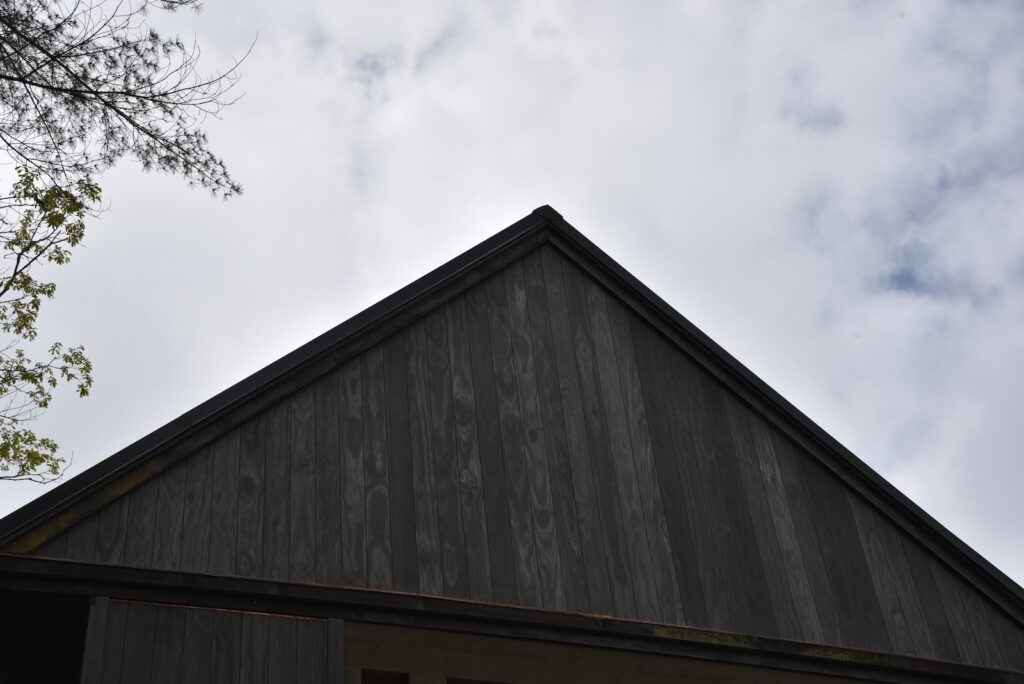 Accoya Grey siding shown in natural light on the upper deck level.