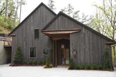 Accoya Grey soffits framing the outdoor entertainment area along the waterfront deck.