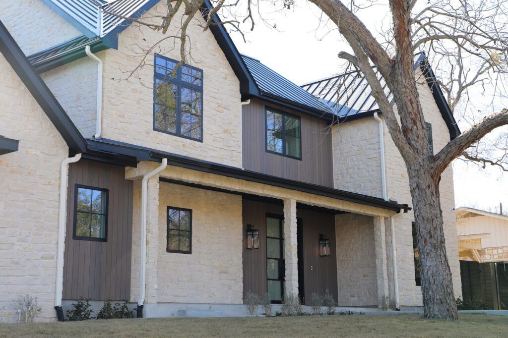 Thermally modified ash siding in Vivid Silver finish accenting the modern façade at the front elevation of the Austin residence.