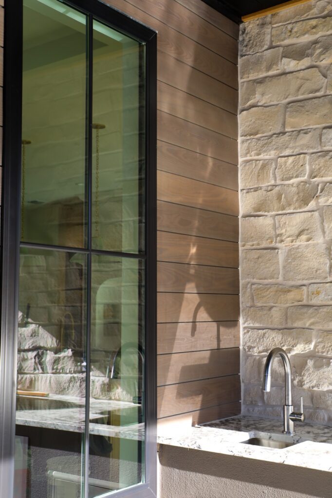 Thermally modified ash siding in Vivid Silver finish with modern window integration at a Paradisa Homes residence in Austin.