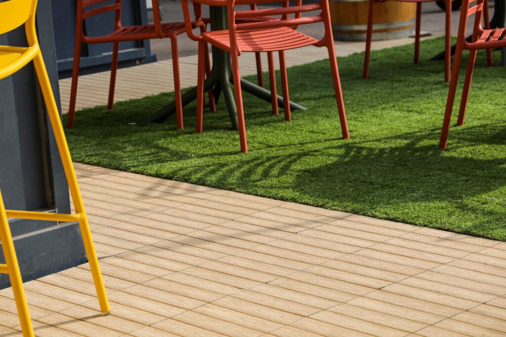 Transition between composite deck tiles and turf tiles