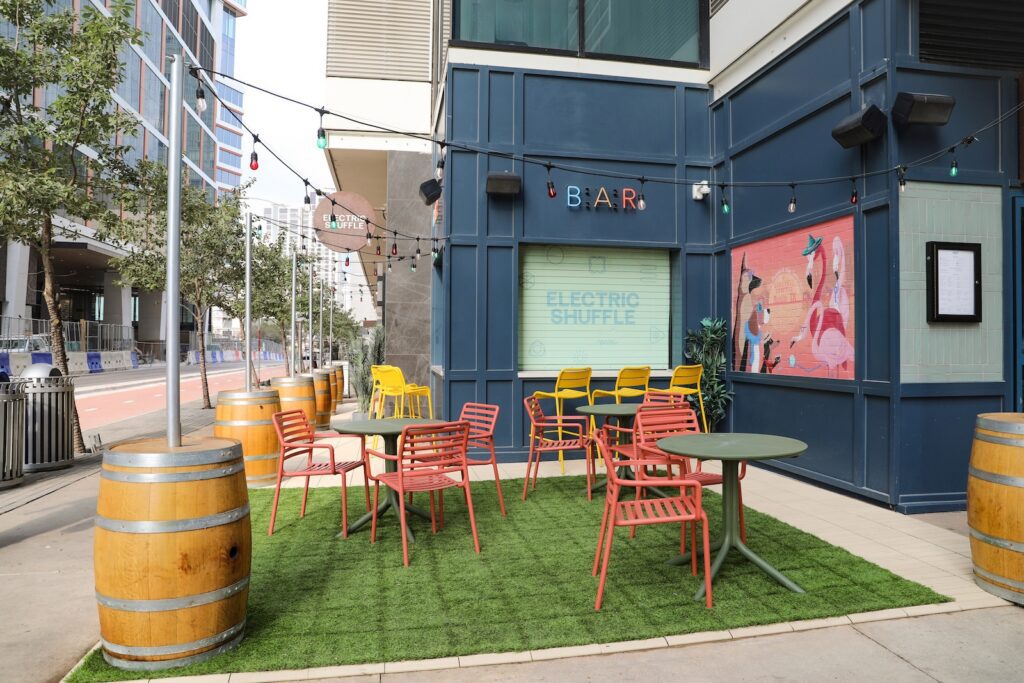 Turf seating area with outdoor furniture at Electric Shuffle