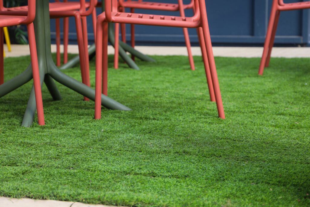 Artificial grass tile detail in commercial patio setting