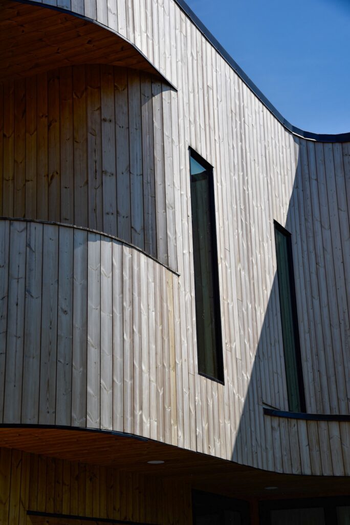 Thermory knotty pine wood exterior with natural aging and soft patina