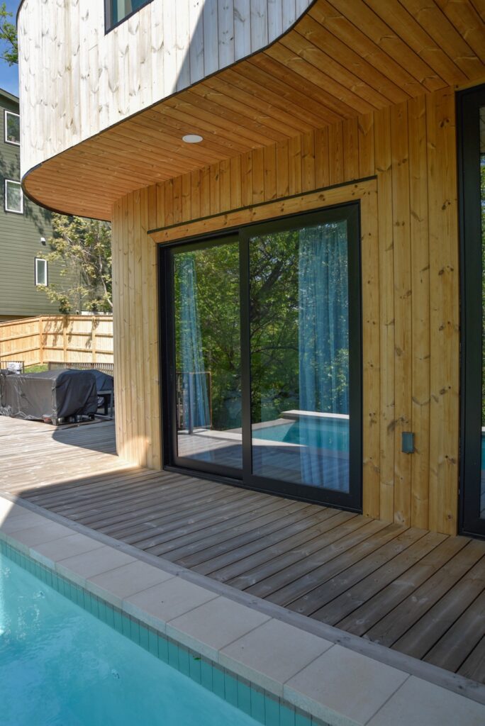 Exterior deck and siding combination using Thermory knotty pine