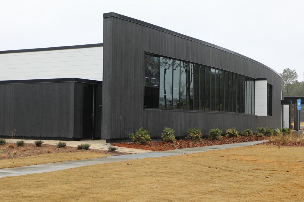 Denmark Library’s 5th Branch features approximately 10,000 square feet of NewTechWood All Weather Siding in Hawaiian Charcoal across exterior cladding, trim, and interior ceiling applications. The project blends sustainable material selection with modern civic architecture, creating a durable, low-maintenance building designed to stay connected to the surrounding landscape.