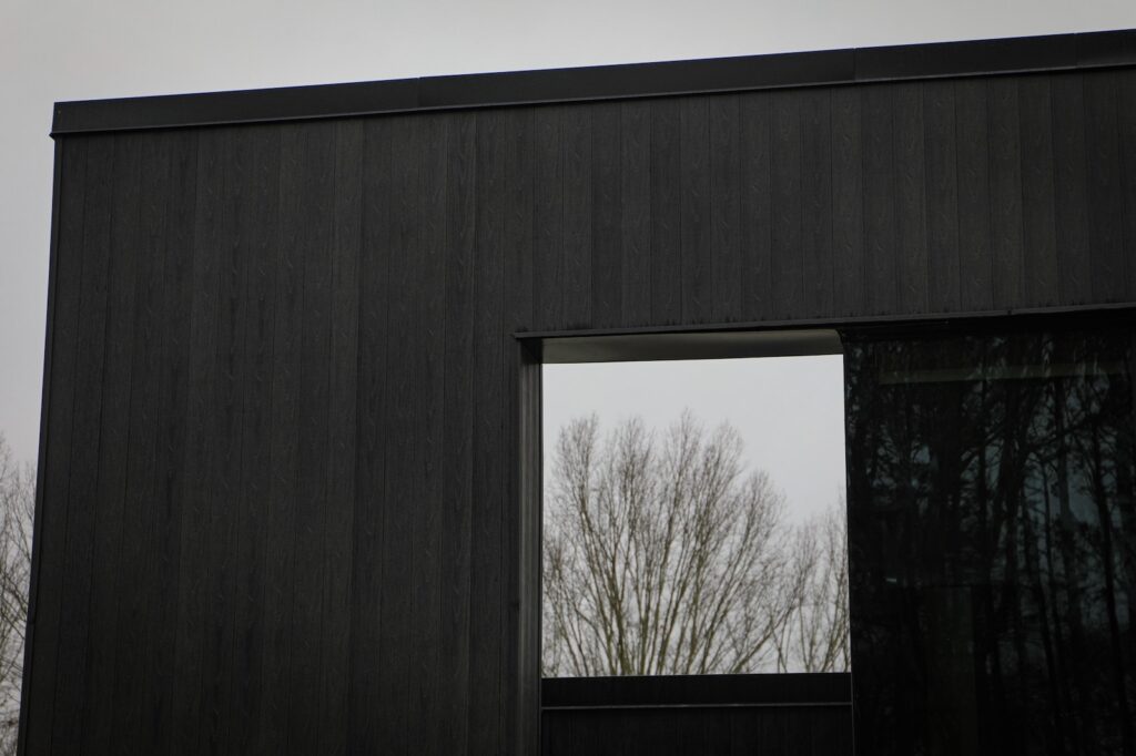 Denmark Library’s 5th Branch features approximately 10,000 square feet of NewTechWood All Weather Siding in Hawaiian Charcoal across exterior cladding, trim, and interior ceiling applications. The project blends sustainable material selection with modern civic architecture, creating a durable, low-maintenance building designed to stay connected to the surrounding landscape.