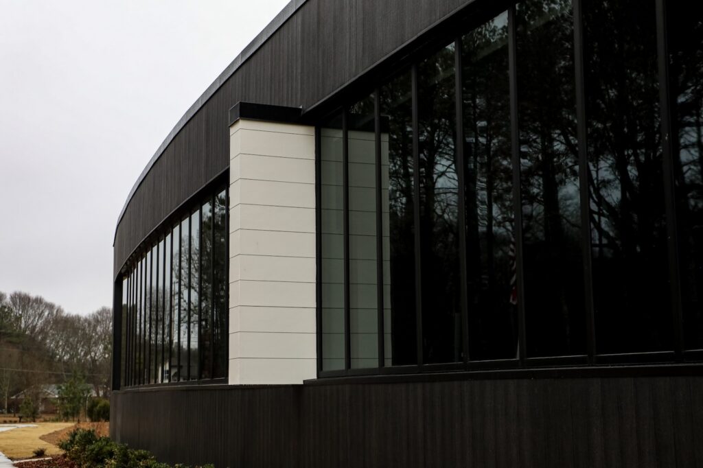 Denmark Library’s 5th Branch features approximately 10,000 square feet of NewTechWood All Weather Siding in Hawaiian Charcoal across exterior cladding, trim, and interior ceiling applications. The project blends sustainable material selection with modern civic architecture, creating a durable, low-maintenance building designed to stay connected to the surrounding landscape.