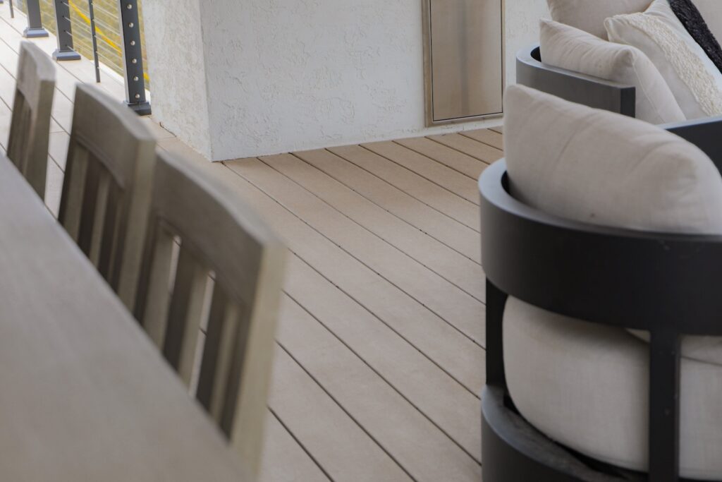 TimberTech Impression Rail with Cable beside outdoor kitchen
