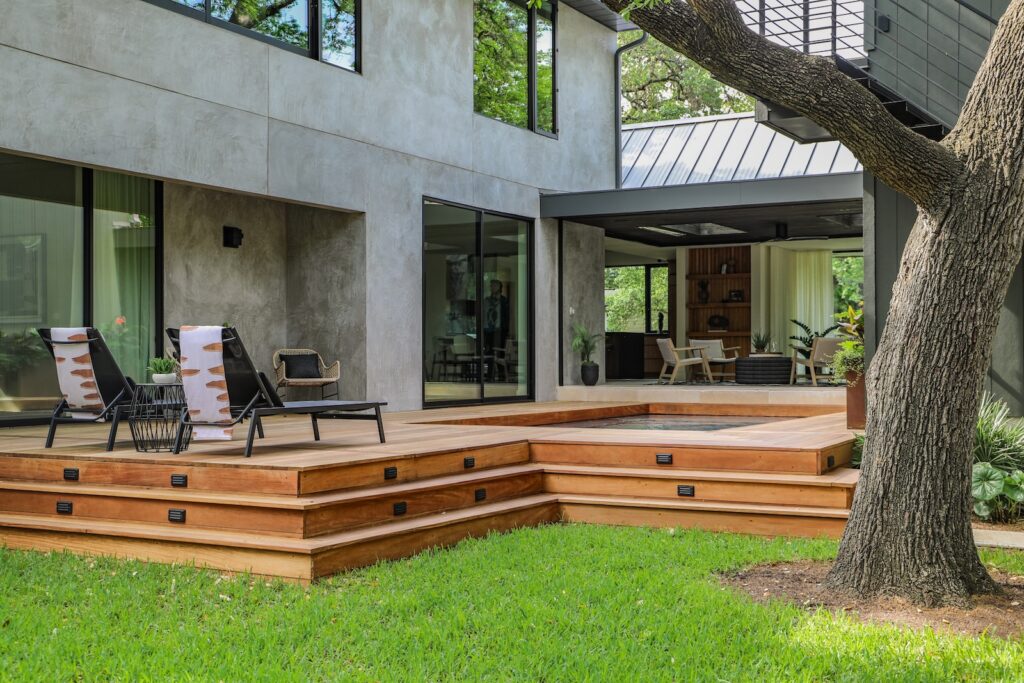 Modern Austin backyard with Garapa hardwood decking and mature oak trees