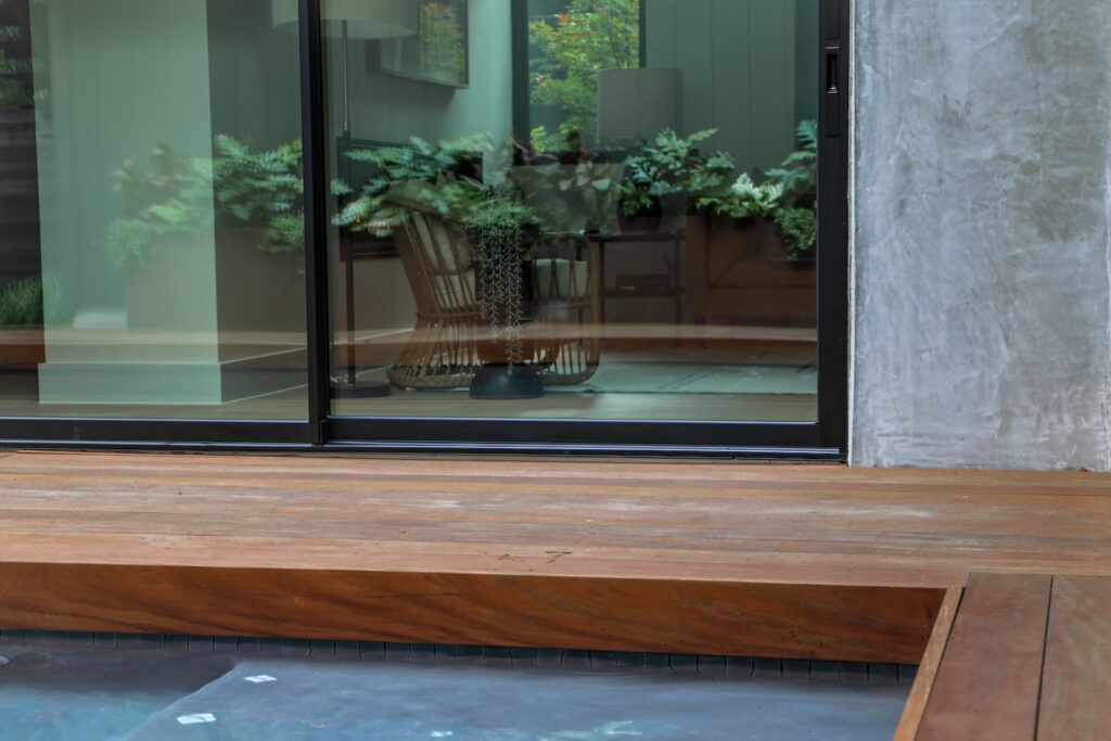 Poolside view of Garapa hardwood decking with contemporary outdoor living space
