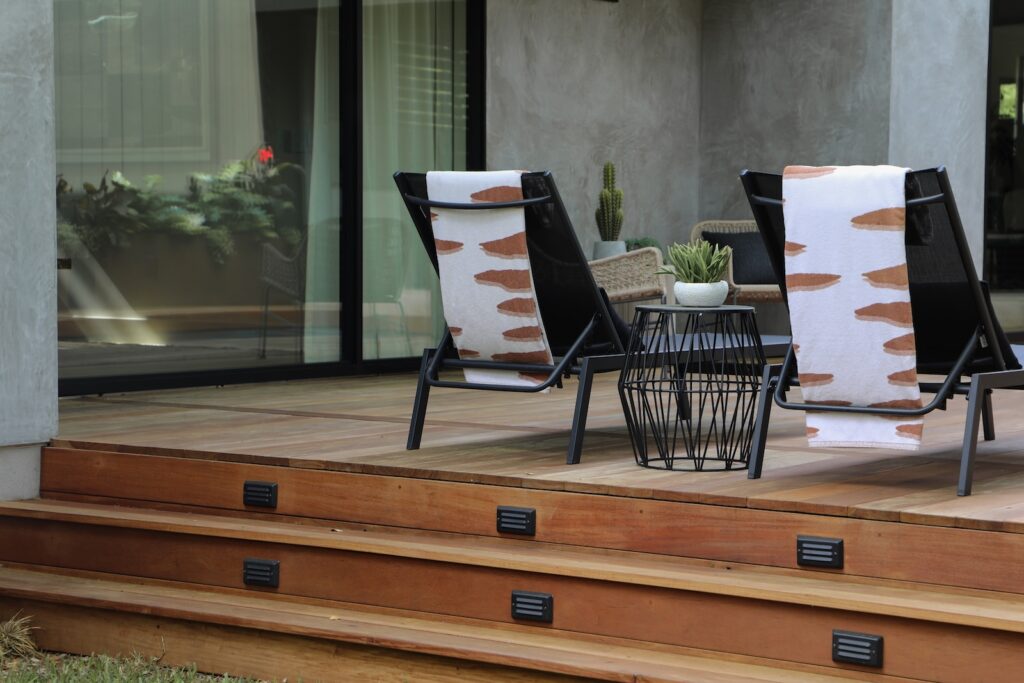 Multi-level Garapa hardwood deck with integrated planters and pool access