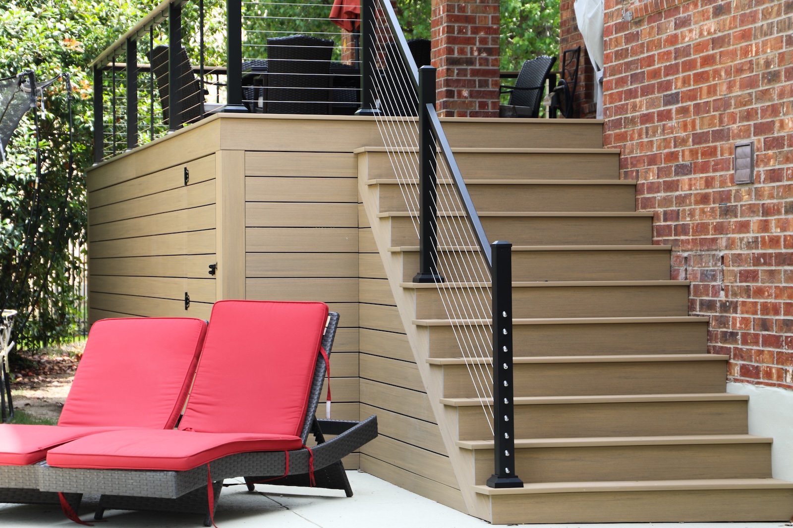 TimberTech decking on a patio & stairs leading to a pool