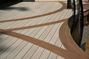 Curved TimberTech Vintage PVC decking following the pool’s edge