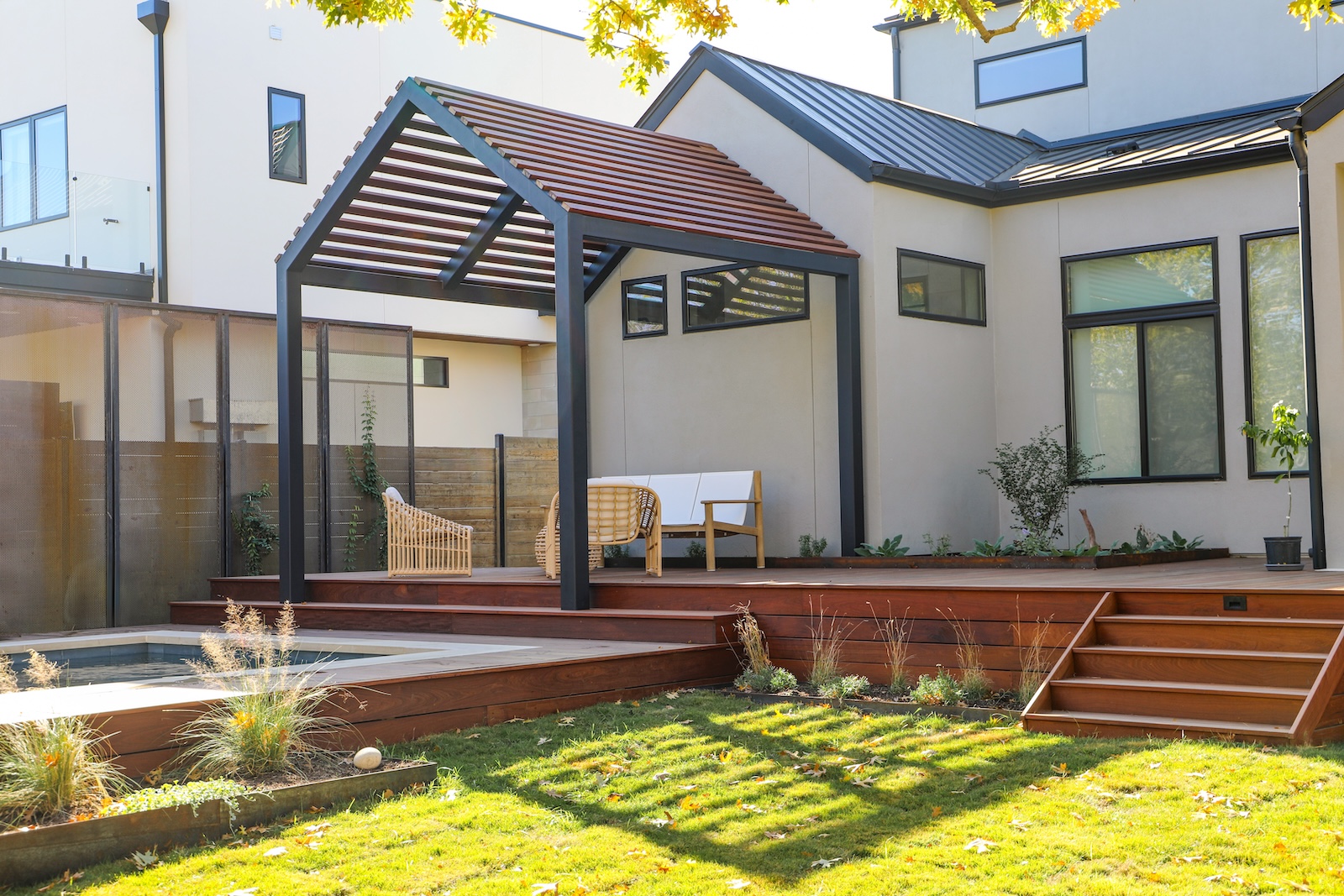Modern Austin backyard featuring an Ipe deck and custom slatted awning