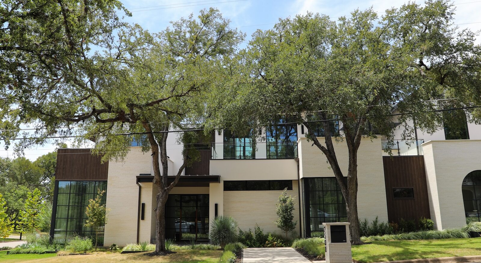 This contemporary Austin home by EEF Custom Homes features Millboard Board & Batten+ Composite Siding in Antique Oak. Molded from real oak and individually hand-colored, Millboard delivers authentic wood texture with the durability of a wood-free composite. The vertical board-and-batten profile creates architectural depth while providing long-lasting, low-maintenance exterior performance.