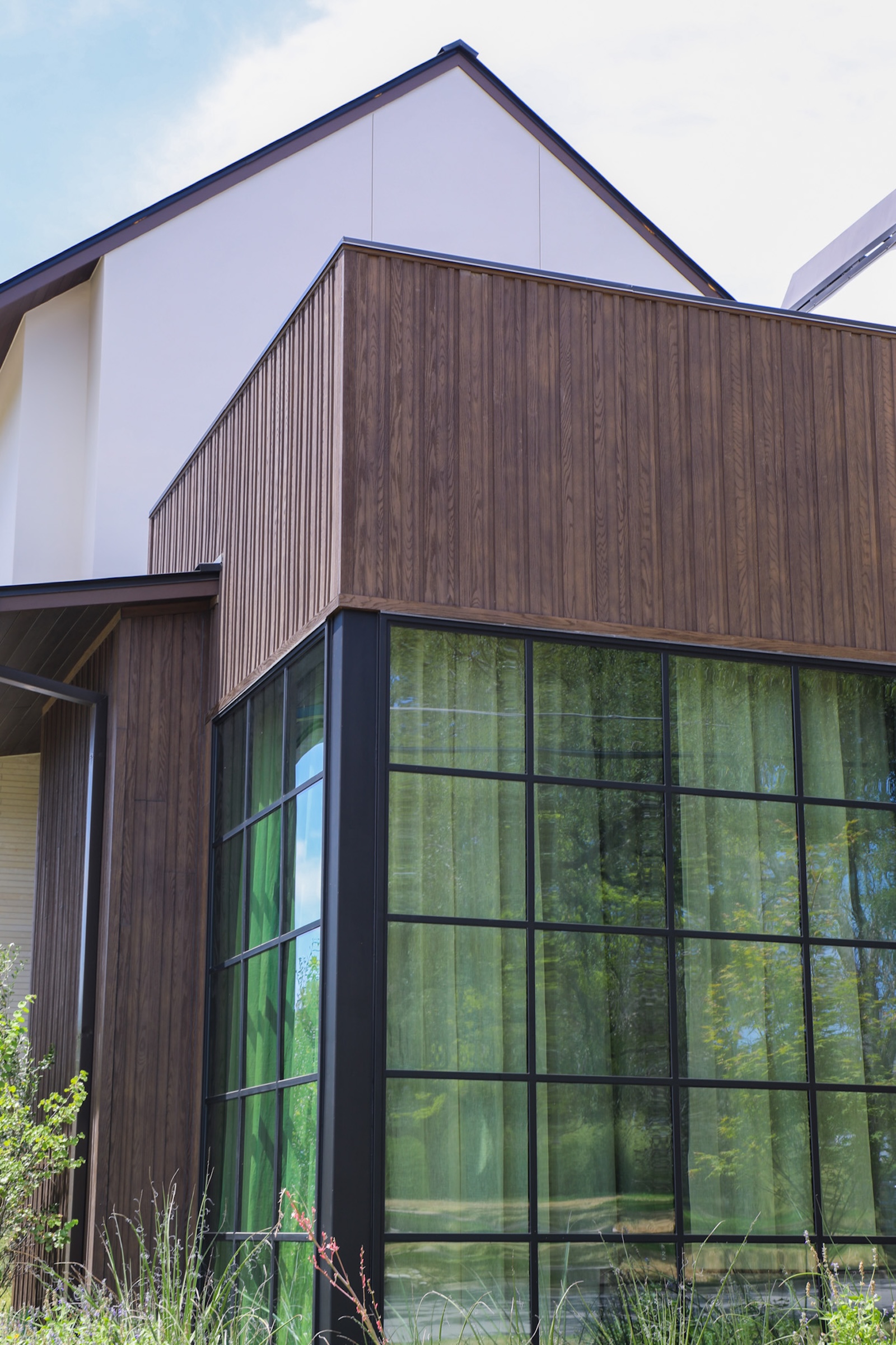 This contemporary Austin home by EEF Custom Homes features Millboard Board & Batten+ Composite Siding in Antique Oak. Molded from real oak and individually hand-colored, Millboard delivers authentic wood texture with the durability of a wood-free composite. The vertical board-and-batten profile creates architectural depth while providing long-lasting, low-maintenance exterior performance.