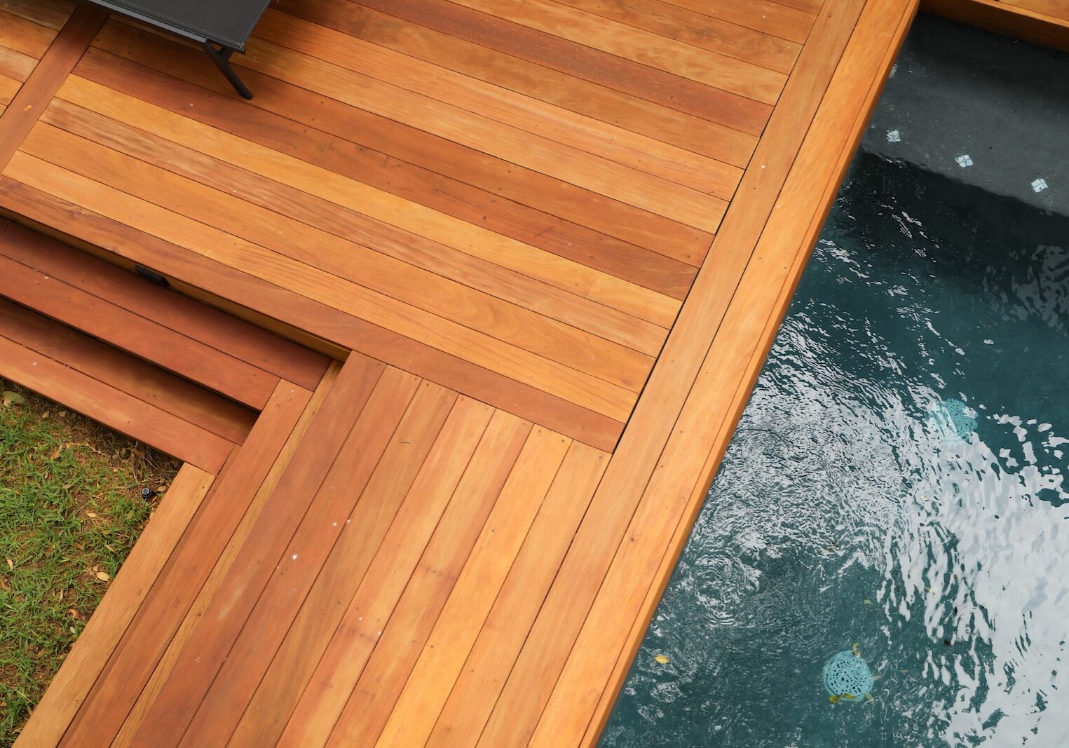 Custom Garapa hardwood decking surrounding a modern pool at an Austin home