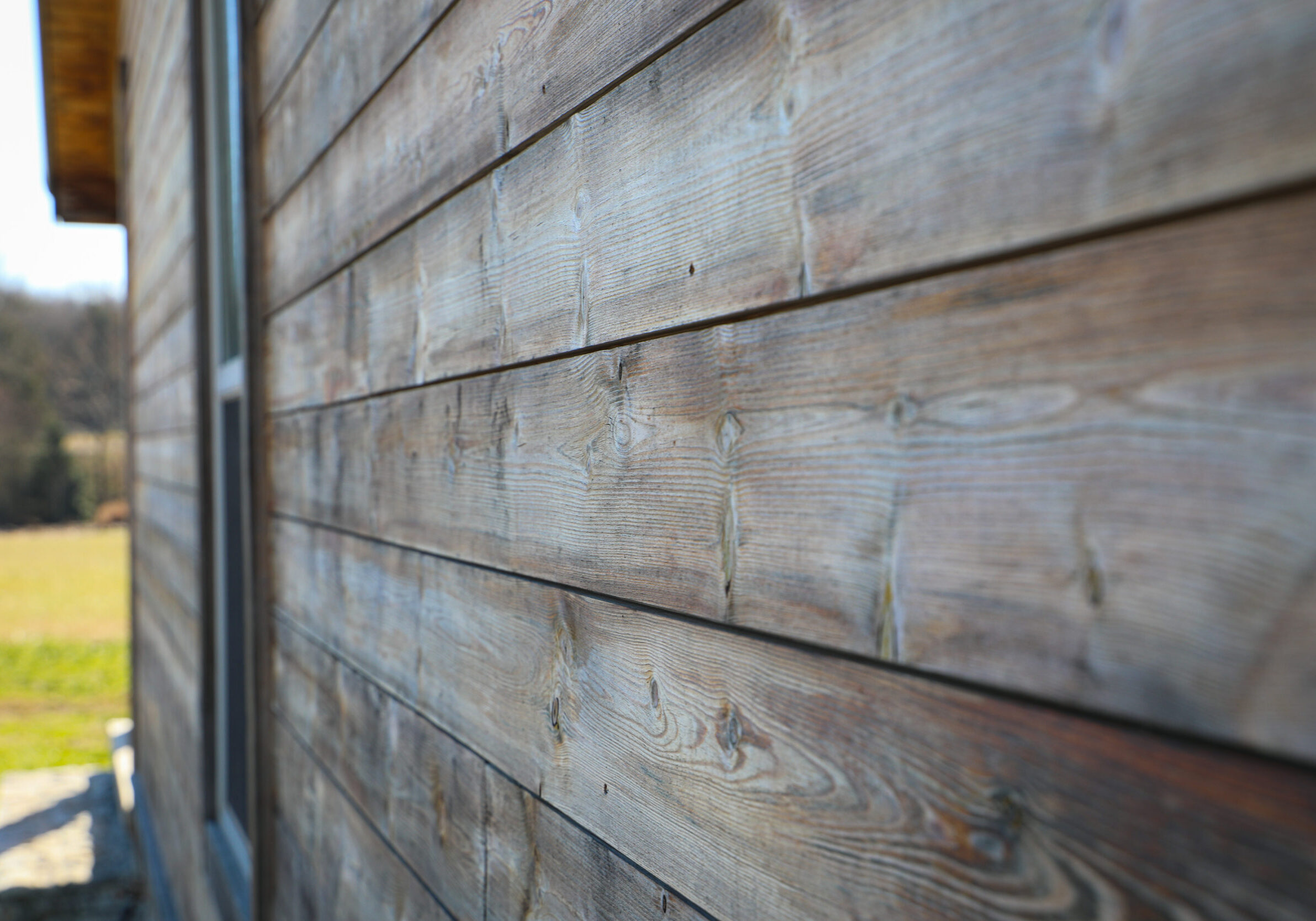 Close-up detail of Kebony wood siding on cabin exterior