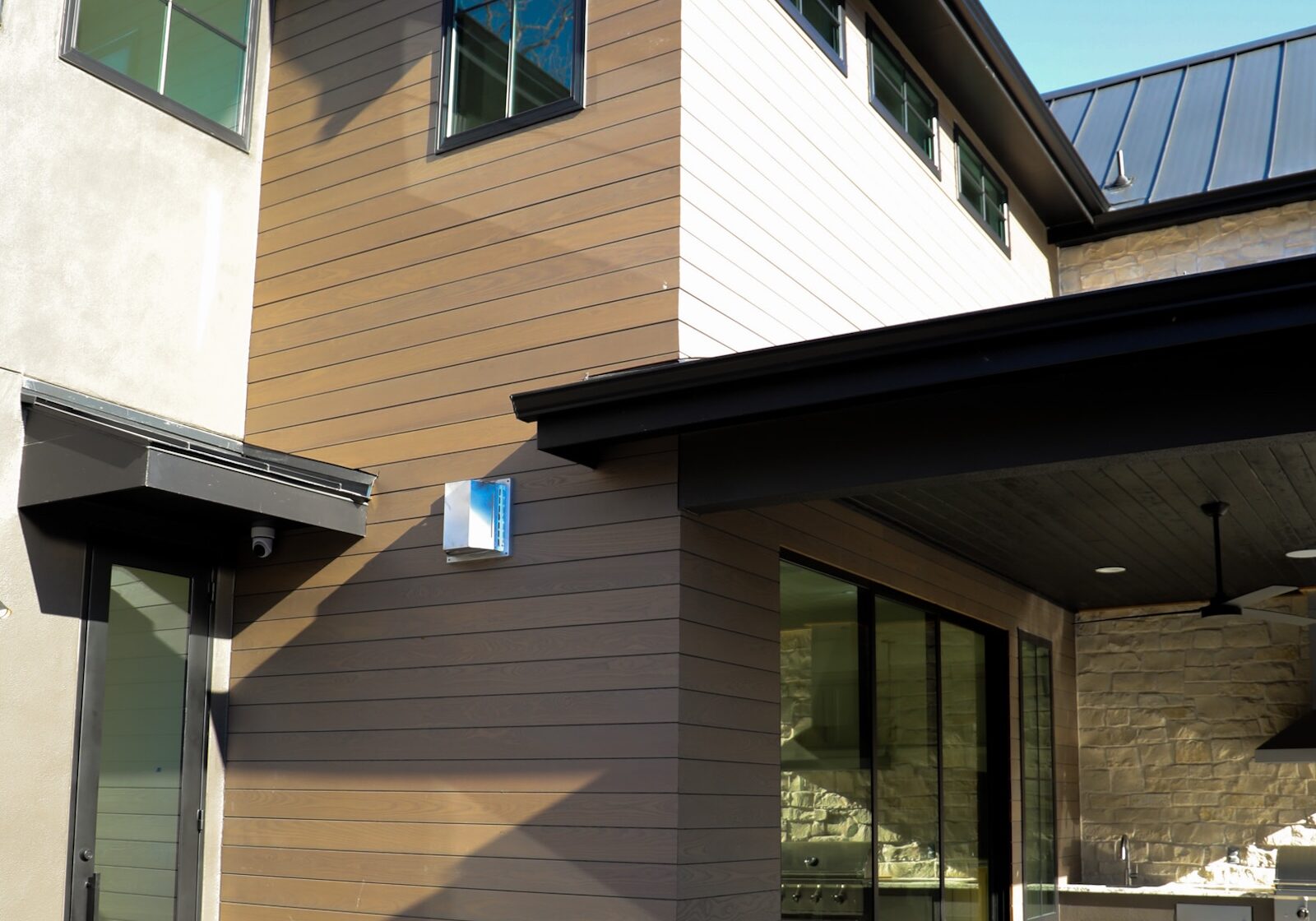 Thermory Benchmark Ash Vivid Silver cladding paired with minimalist design elements on a custom Austin home exterior.